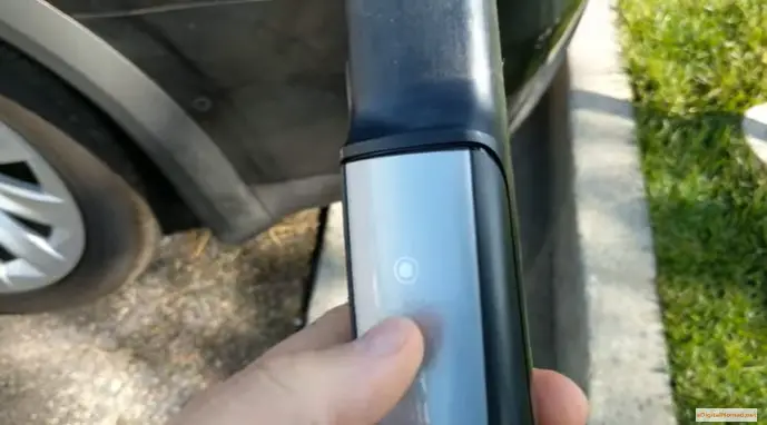 By using the charger handle