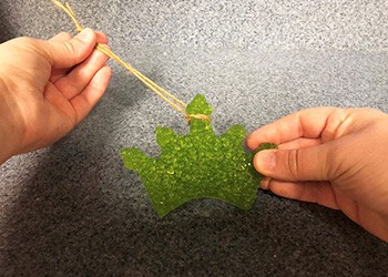 Loop the string around a few beads or through the hole.