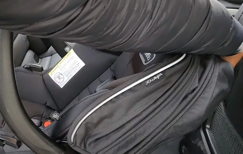 Unhook the car seat straps.